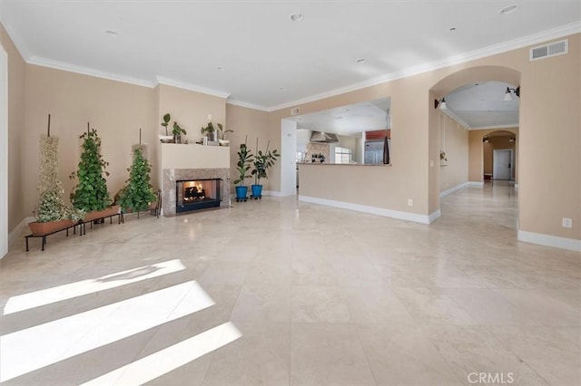 unfurnished living room with crown molding and a multi sided fireplace