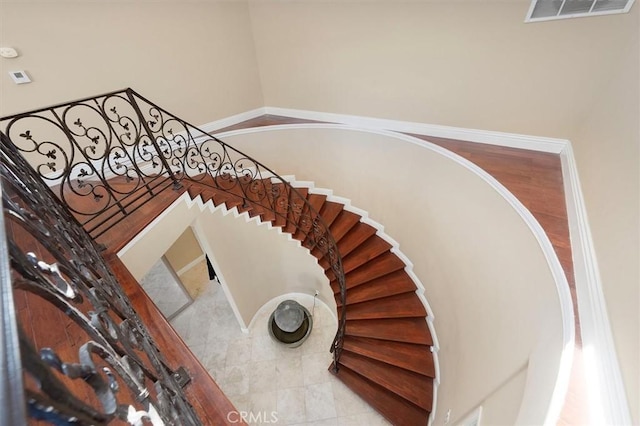 staircase featuring tile patterned flooring