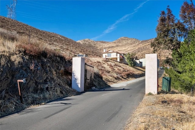view of street featuring a mountain view and aphalt driveway