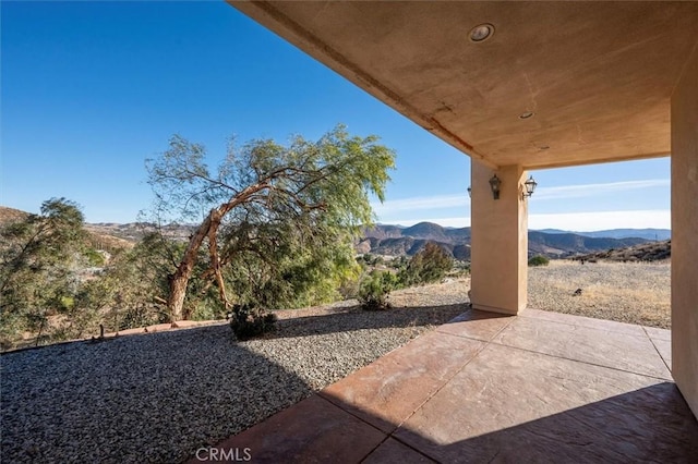 view of patio / terrace with a mountain view