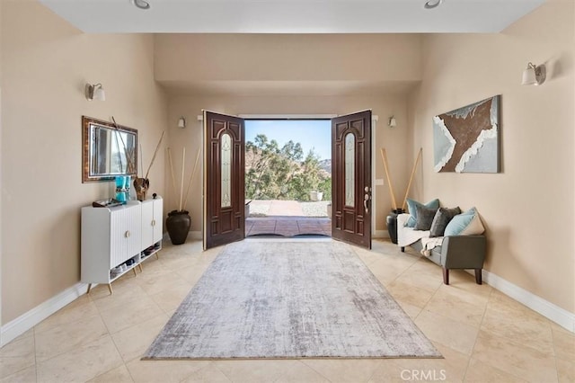 entrance foyer featuring light tile patterned floors and baseboards