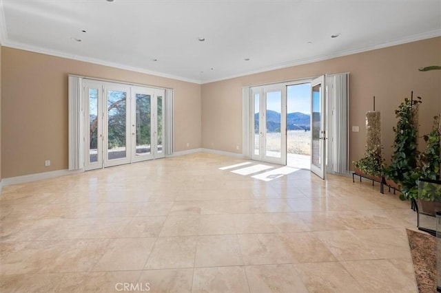empty room with french doors, ornamental molding, marble finish floor, and baseboards