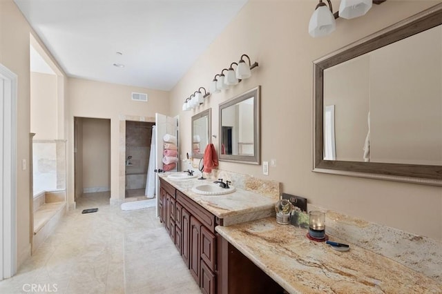 full bath featuring a tile shower, a sink, french doors, and visible vents