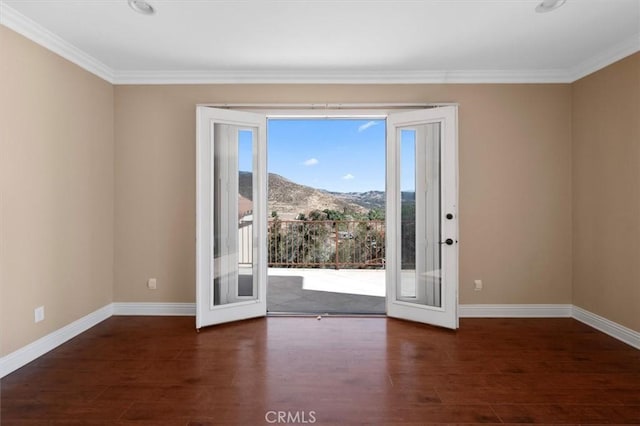 entryway with a mountain view, crown molding, and french doors