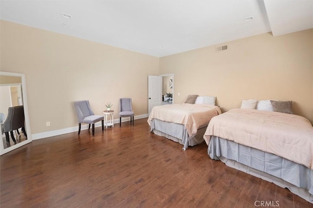 bedroom featuring visible vents, wood finished floors, and baseboards