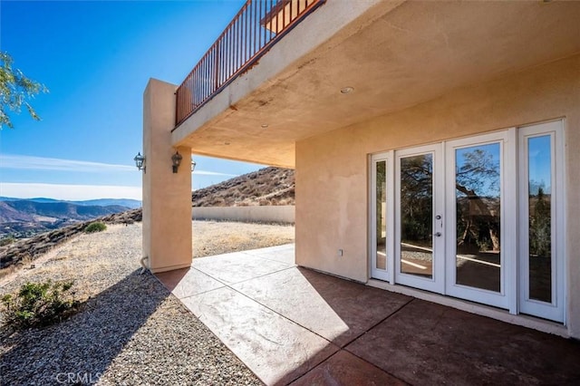 view of patio with french doors and a mountain view