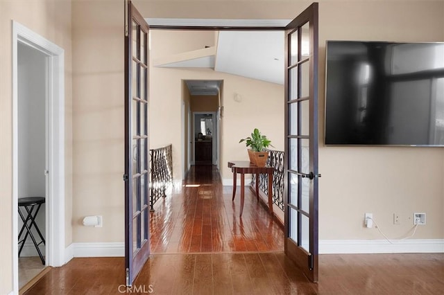 hall with french doors, dark hardwood / wood-style floors, and vaulted ceiling