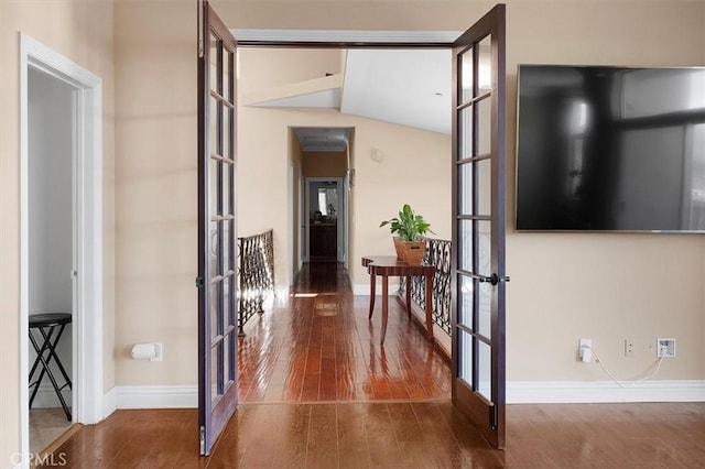 hall featuring wood finished floors, french doors, and baseboards