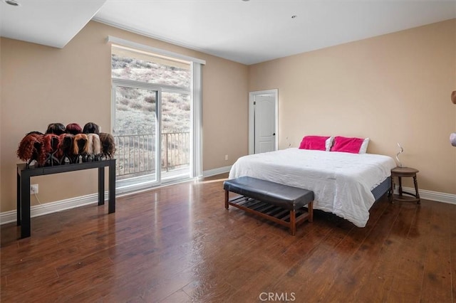 bedroom with access to outside and dark hardwood / wood-style flooring