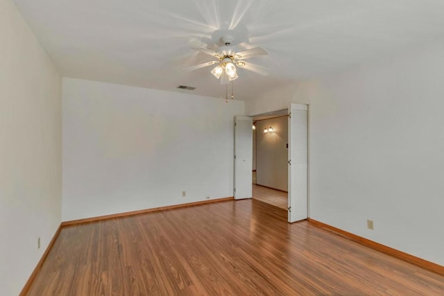 unfurnished room featuring hardwood / wood-style floors and ceiling fan