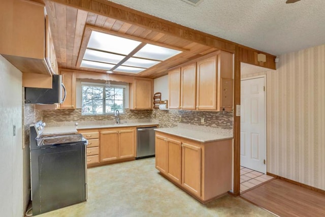 kitchen featuring appliances with stainless steel finishes, sink, backsplash, and light brown cabinetry