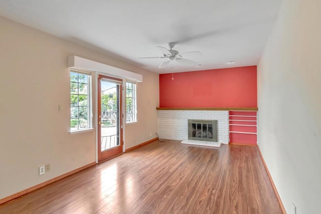 unfurnished living room featuring hardwood / wood-style floors, a fireplace, and ceiling fan