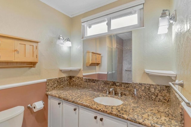 bathroom featuring crown molding, vanity, and toilet