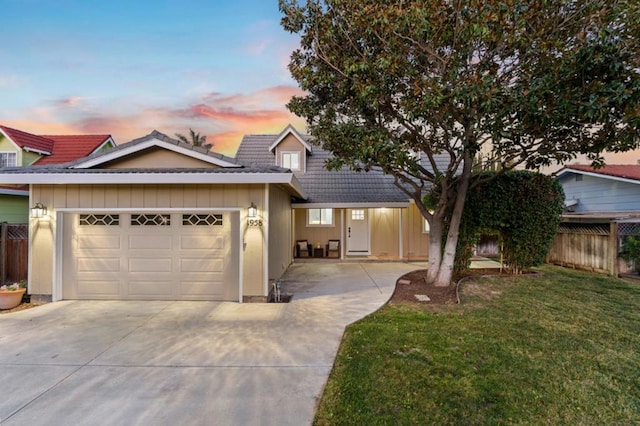 view of front of house featuring a garage and a lawn