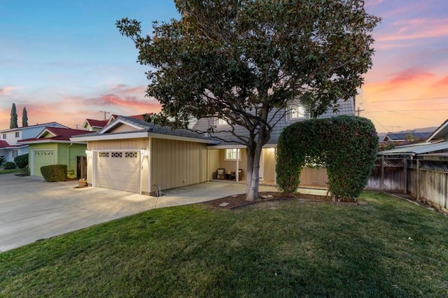 view of front of house featuring a yard and a garage