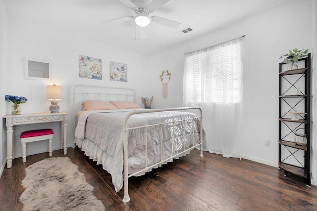 bedroom with dark hardwood / wood-style flooring and ceiling fan