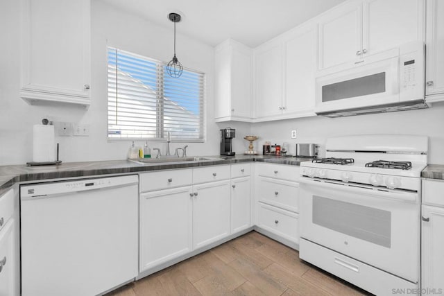 kitchen featuring pendant lighting, sink, white cabinets, light hardwood / wood-style floors, and white appliances