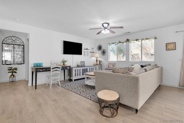 living room with light hardwood / wood-style floors and ceiling fan