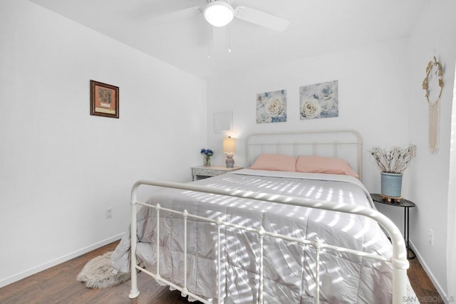 bedroom with dark hardwood / wood-style flooring and ceiling fan