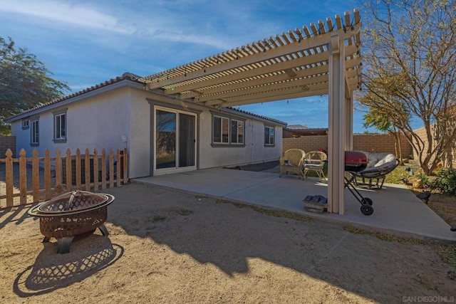 back of house featuring a patio, a pergola, and an outdoor fire pit