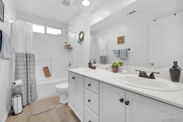 full bathroom with toilet, vanity, shower / bathtub combination with curtain, and hardwood / wood-style floors