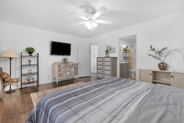 bedroom featuring ensuite bathroom, dark wood-type flooring, and ceiling fan