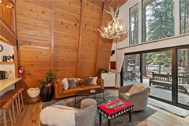 interior space with a wealth of natural light, light hardwood / wood-style floors, and a high ceiling