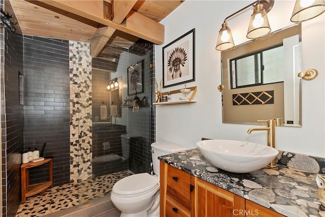 full bathroom with a stall shower, wood ceiling, vanity, and toilet