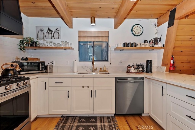 kitchen with wood ceiling, sink, beam ceiling, and stainless steel appliances