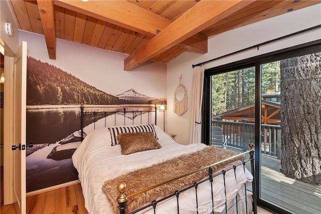 bedroom featuring hardwood / wood-style floors, wood ceiling, access to outside, and beamed ceiling