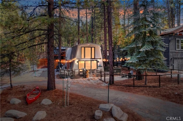 view of front of home featuring a storage shed