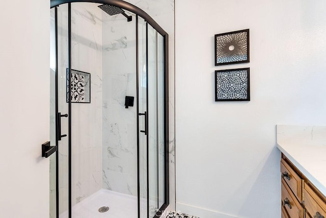 bathroom featuring vanity and a shower with shower door