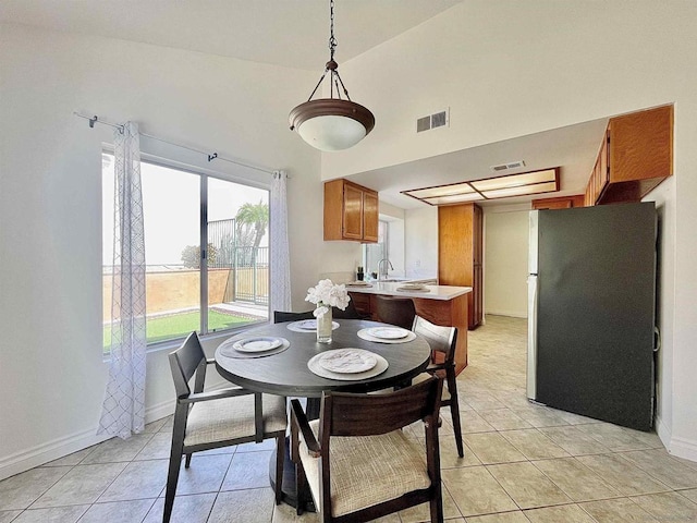 dining area featuring sink, a wealth of natural light, and light tile patterned floors