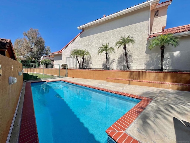 view of swimming pool featuring a patio area