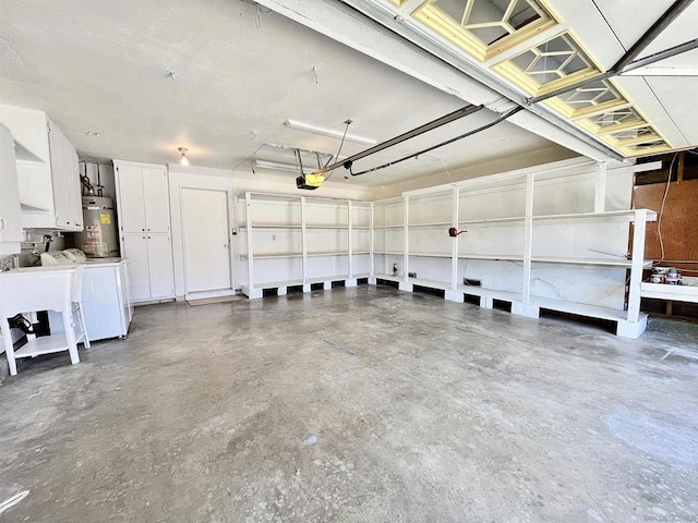 garage with gas water heater and washer and dryer