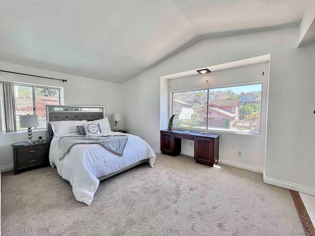 carpeted bedroom with vaulted ceiling