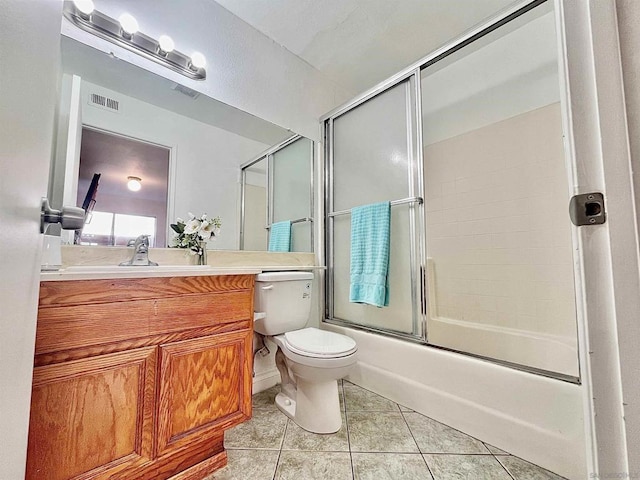 full bathroom with enclosed tub / shower combo, vanity, toilet, and tile patterned flooring