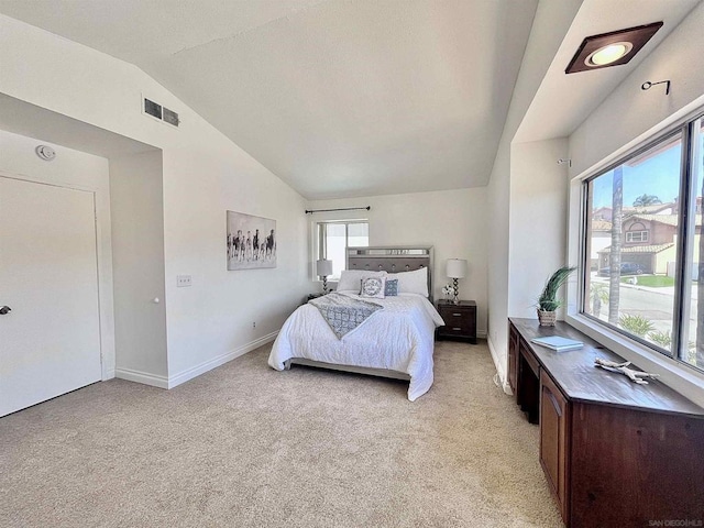 carpeted bedroom featuring lofted ceiling