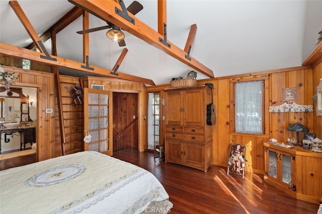 bedroom featuring vaulted ceiling with beams, dark wood-type flooring, and wood walls