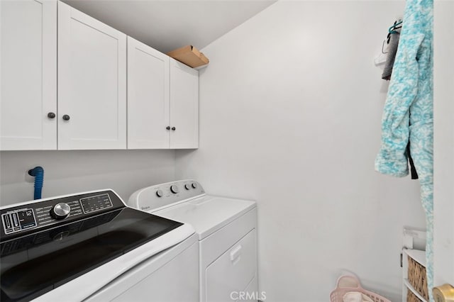 laundry area with cabinets and washing machine and clothes dryer