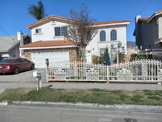 mediterranean / spanish home with a garage