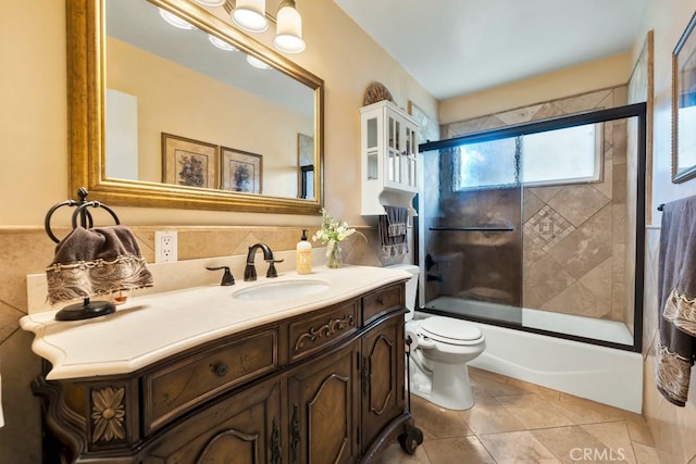 full bathroom with vanity, tile patterned floors, toilet, and combined bath / shower with glass door