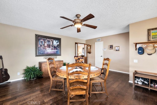 dining room with ceiling fan, dark hardwood / wood-style floors, and a textured ceiling