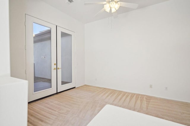 unfurnished room featuring french doors and ceiling fan