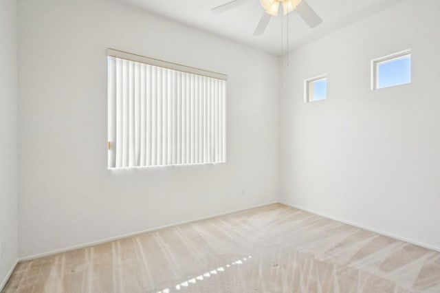 carpeted spare room with ceiling fan