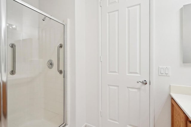 bathroom featuring vanity and an enclosed shower