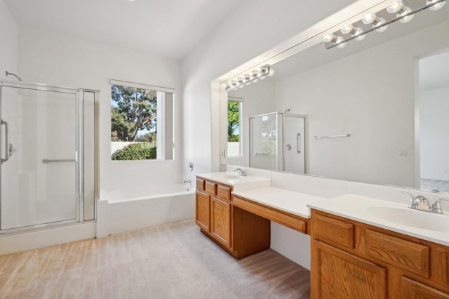 bathroom with vanity and shower with separate bathtub