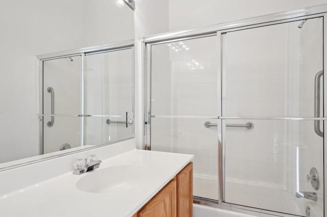 bathroom featuring vanity and bath / shower combo with glass door