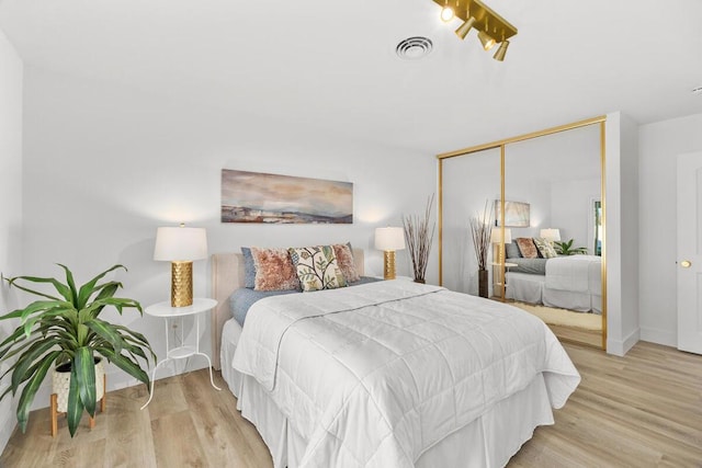 bedroom featuring a closet and light wood-type flooring