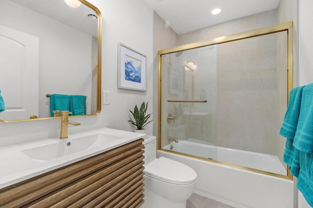 full bathroom featuring toilet, vanity, and shower / bath combination with glass door